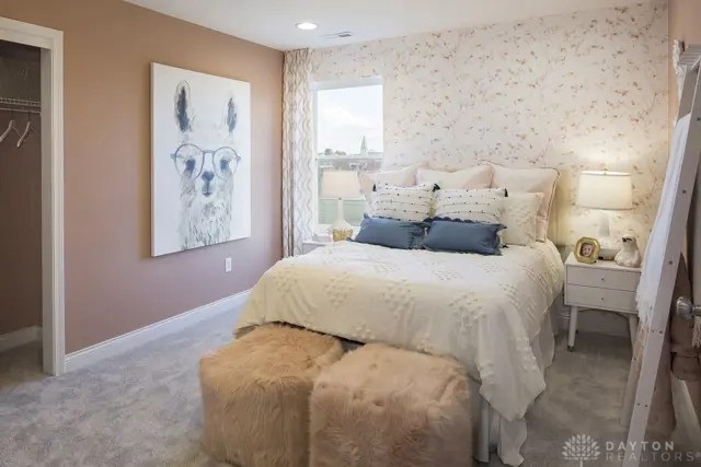 carpeted bedroom featuring baseboards