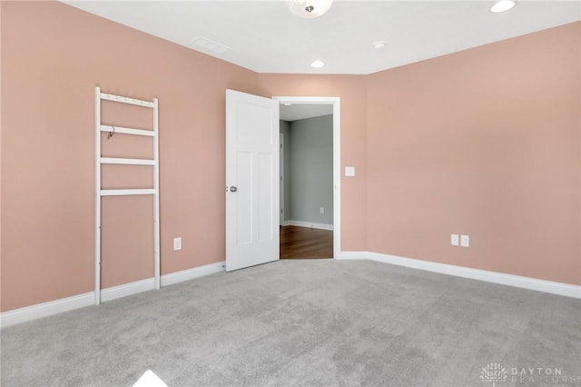unfurnished bedroom featuring recessed lighting, baseboards, and carpet