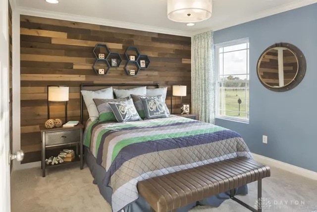 bedroom with baseboards, wood walls, carpet, and crown molding