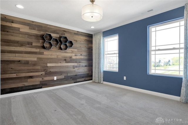 carpeted empty room with visible vents, baseboards, and a healthy amount of sunlight