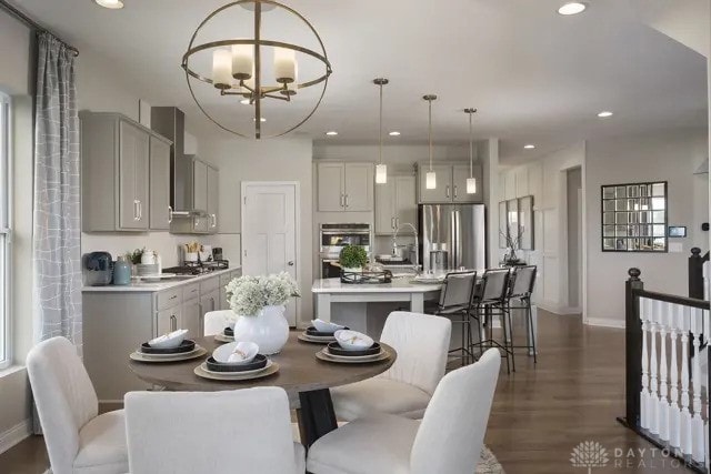 dining area featuring an inviting chandelier, recessed lighting, and dark wood-type flooring