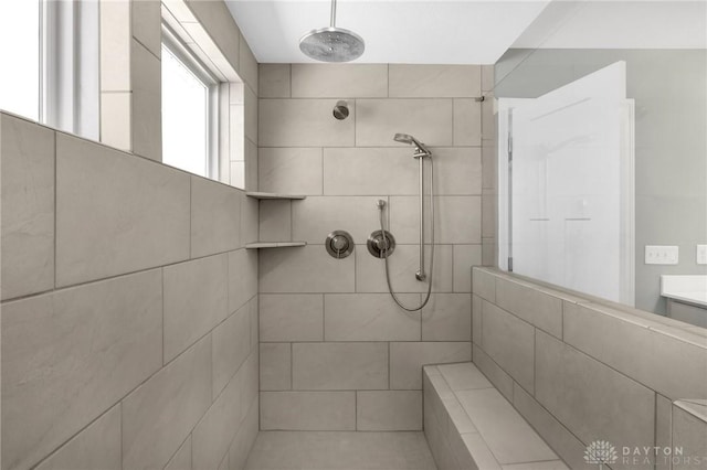 bathroom with a tile shower