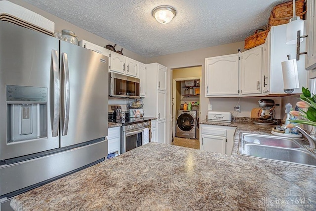 631 Alpine Pl, Trenton, OH 45067 - kitchen featuring white cabinets, appliances with stainless steel finishes, a sink, and independent washer and dryer