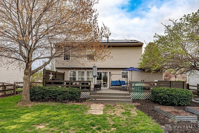631 Alpine Pl, Trenton, OH 45067 - rear view of property with roof mounted solar panels, a vegetable garden, fence, a yard, and a wooden deck