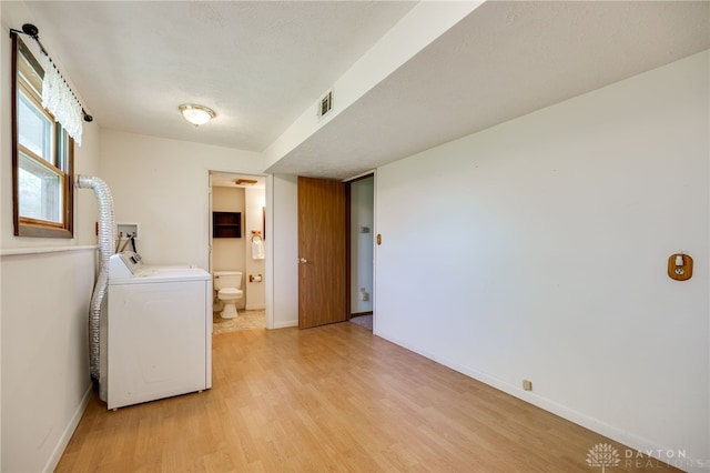 6139 N State Route 48, Clearcreek Twp, OH 45036 - laundry room with washer / dryer, light wood-type flooring, and baseboards