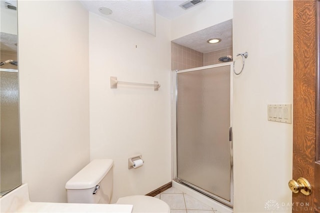 full bathroom with tile patterned flooring, a shower stall, visible vents, and toilet