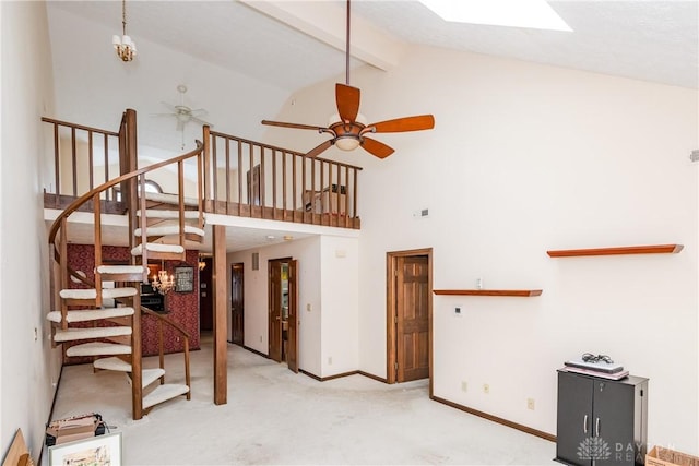 unfurnished living room featuring stairs, carpet floors, baseboards, high vaulted ceiling, and ceiling fan