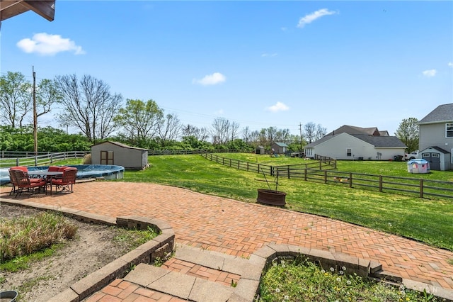 view of patio / terrace with a storage unit, an outbuilding, outdoor dining area, and a fenced backyard