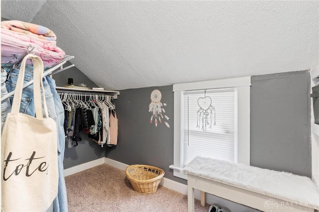 spacious closet featuring lofted ceiling and carpet floors