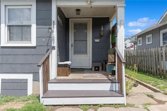 doorway to property featuring fence