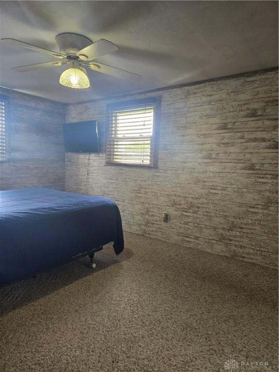 bedroom with a ceiling fan and carpet flooring