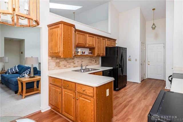 1405 Ashworth Ct, Dayton, OH 45459 - kitchen featuring a skylight, high vaulted ceiling, a sink, light countertops, and backsplash