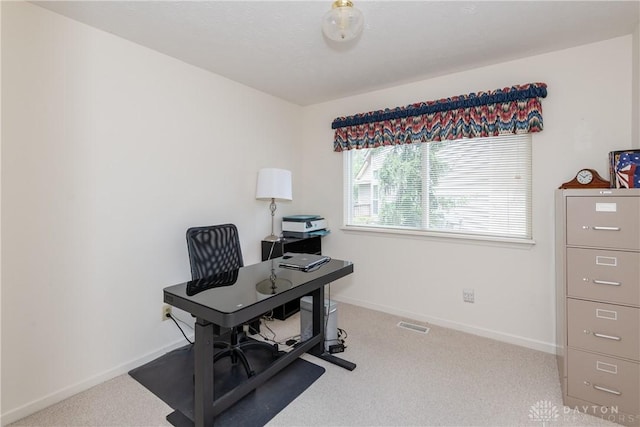 office area featuring baseboards, visible vents, and carpet floors
