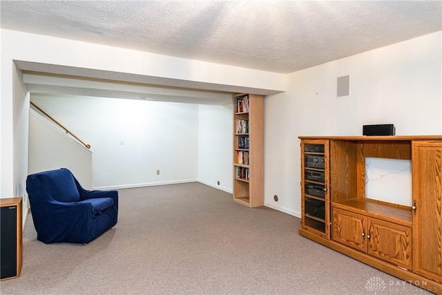 unfurnished room with a textured ceiling, visible vents, and carpet floors