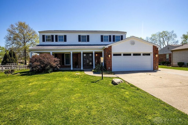 traditional-style home featuring fence, concrete driveway, a front yard, and a garage
