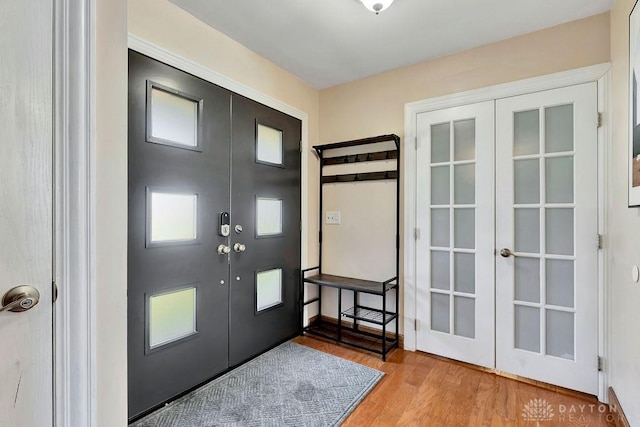 foyer entrance with french doors and light wood-style flooring