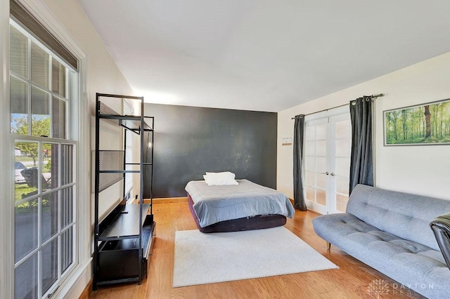 bedroom featuring wood finished floors and french doors