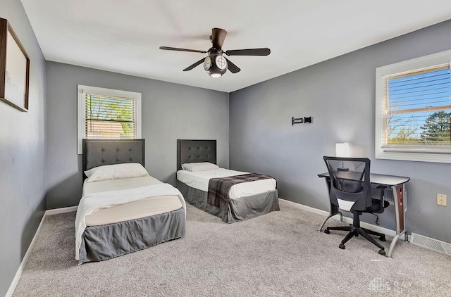 carpeted bedroom with a ceiling fan and baseboards