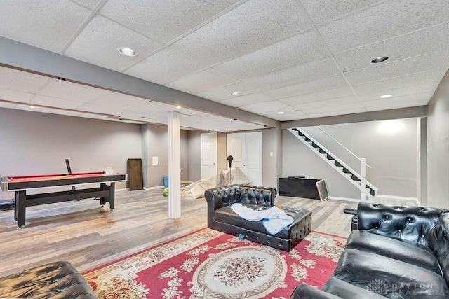 interior space featuring recessed lighting, a paneled ceiling, wood finished floors, and baseboards