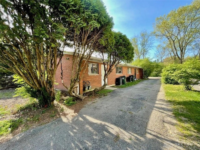 view of side of property featuring brick siding