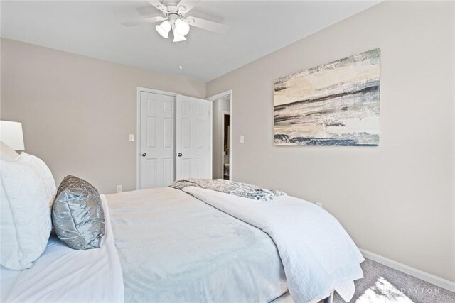 bedroom with ceiling fan, carpet, and baseboards