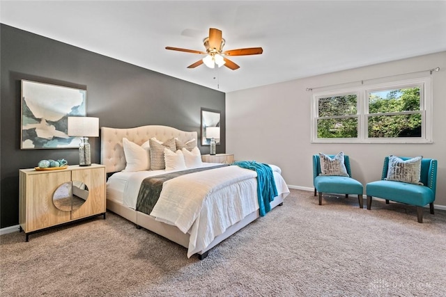 carpeted bedroom featuring baseboards and a ceiling fan