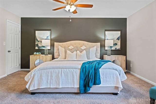 carpeted bedroom with baseboards and a ceiling fan