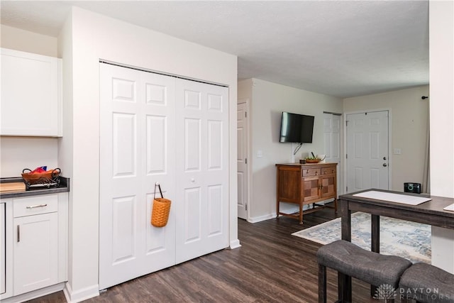 game room with dark wood-style flooring and baseboards