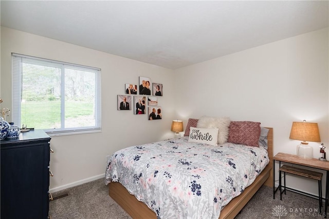 bedroom featuring carpet and baseboards
