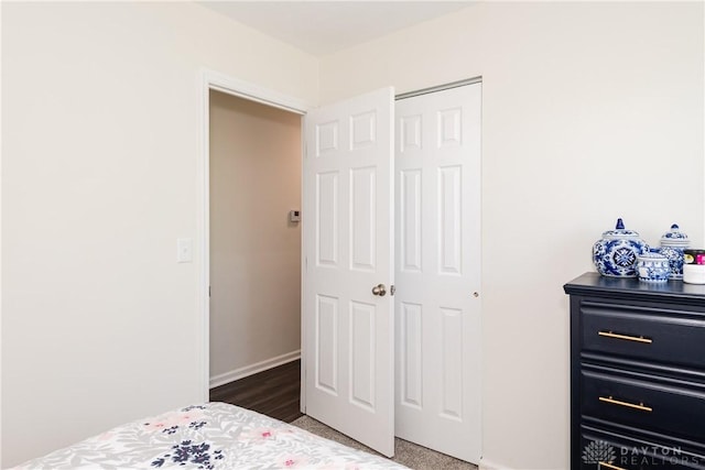 bedroom with a closet and baseboards