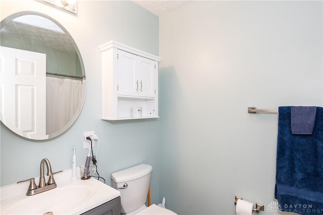full bath with toilet and vanity