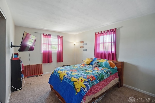 bedroom featuring carpet flooring and baseboards