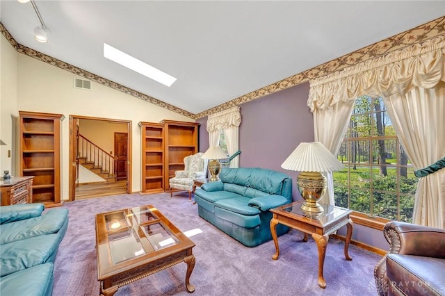 carpeted living room featuring lofted ceiling with skylight, stairs, visible vents, and a healthy amount of sunlight