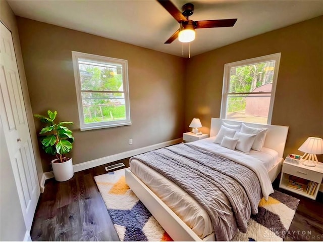 bedroom featuring wood finished floors, ceiling fan, and baseboards