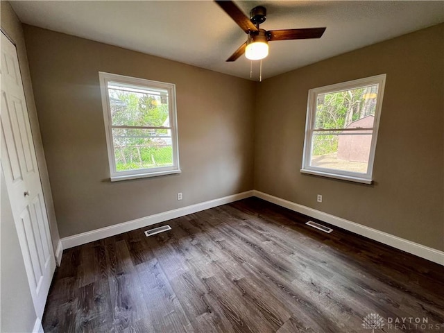 unfurnished bedroom with multiple windows, baseboards, and visible vents