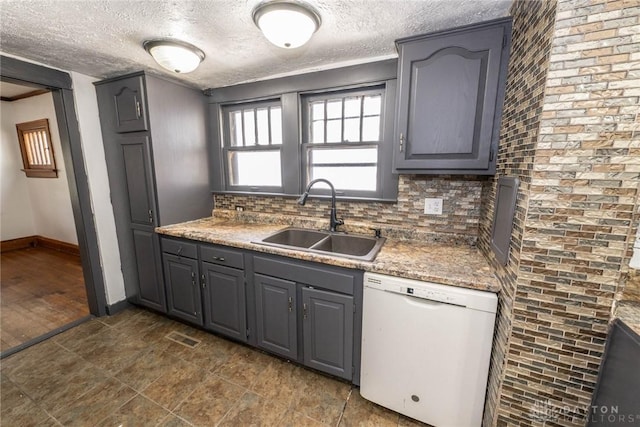 kitchen featuring gray cabinetry, a textured ceiling, dishwasher, and a sink