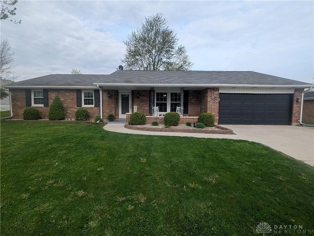ranch-style home with a porch, a front yard, a garage, driveway, and brick siding