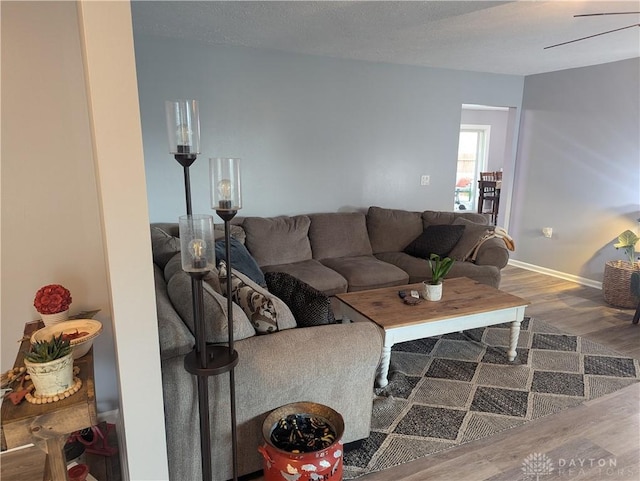 living area with wood finished floors and baseboards