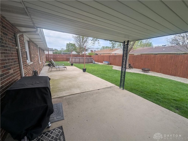 view of patio with an outdoor fire pit, area for grilling, and a fenced backyard