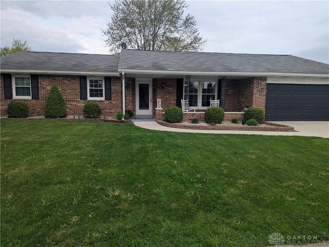 ranch-style house with driveway, a front yard, a porch, brick siding, and a garage