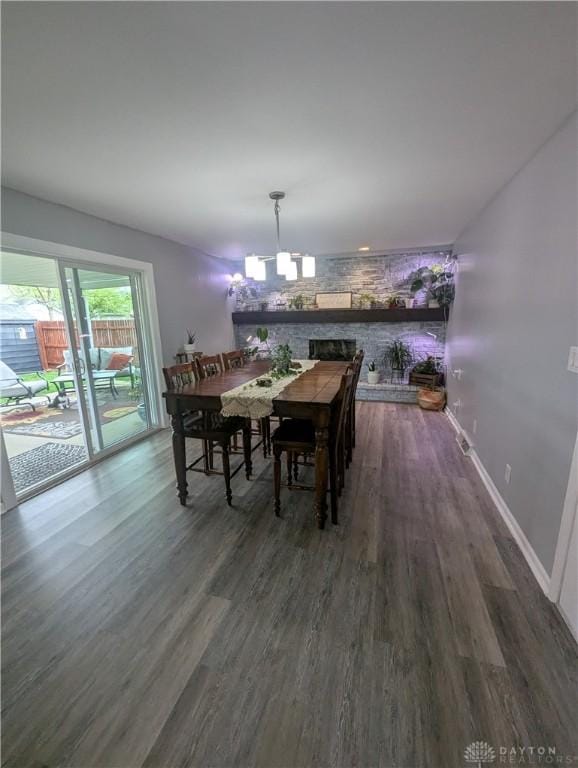dining area with a notable chandelier and wood finished floors