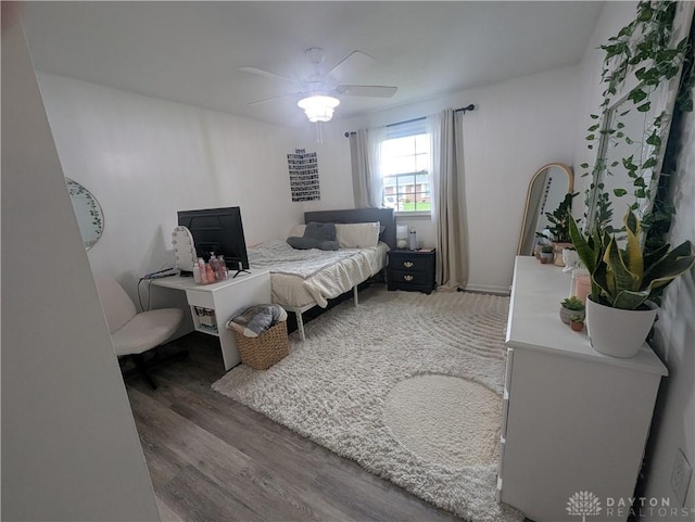 bedroom with wood finished floors and a ceiling fan