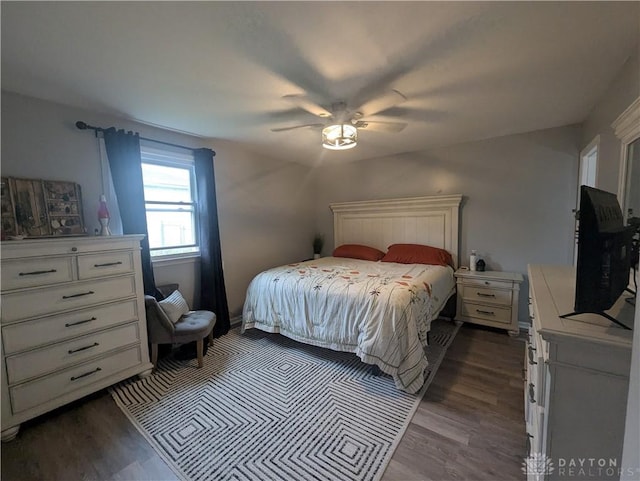 bedroom featuring a ceiling fan and dark wood-type flooring