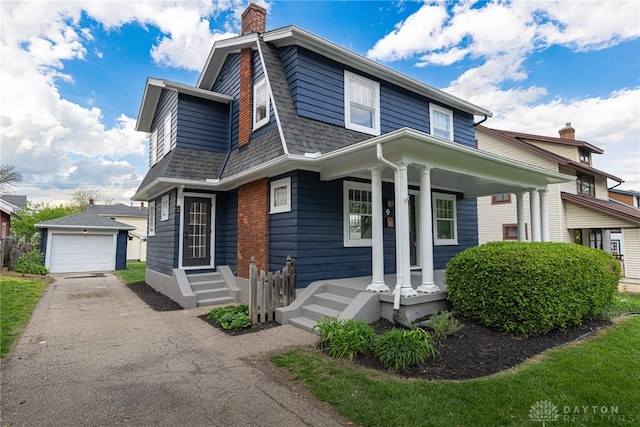 9 Wiltshire Blvd, Oakwood, OH 45419 - view of front of home featuring an outbuilding, a chimney, covered porch, aphalt driveway, and roof with shingles