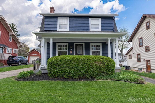 9 Wiltshire Blvd, Oakwood, OH 45419 - view of front facade with covered porch, a chimney, and a front yard