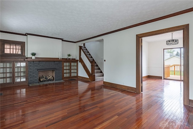 9 Wiltshire Blvd, Oakwood, OH 45419 - unfurnished living room featuring baseboards, stairway, a textured ceiling, and wood-type flooring