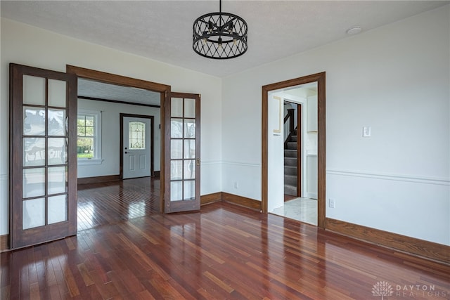 9 Wiltshire Blvd, Oakwood, OH 45419 - unfurnished dining area featuring baseboards, stairs, hardwood / wood-style floors, and french doors