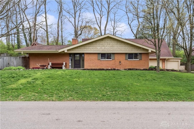 5262 Bittersweet Dr, Washington Twp, OH 45429 - single story home with a front yard, brick siding, a chimney, an attached garage, and fence