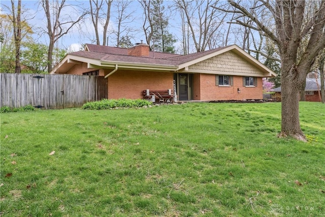 5262 Bittersweet Dr, Washington Twp, OH 45429 - exterior space featuring brick siding, a lawn, a chimney, and fence