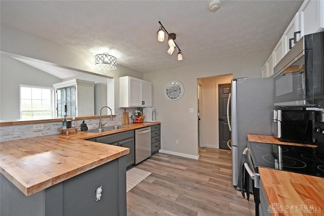 171 Pleasant Hill Blvd, Franklin, OH 45005 - kitchen with stainless steel dishwasher, a sink, white cabinetry, and wooden counters